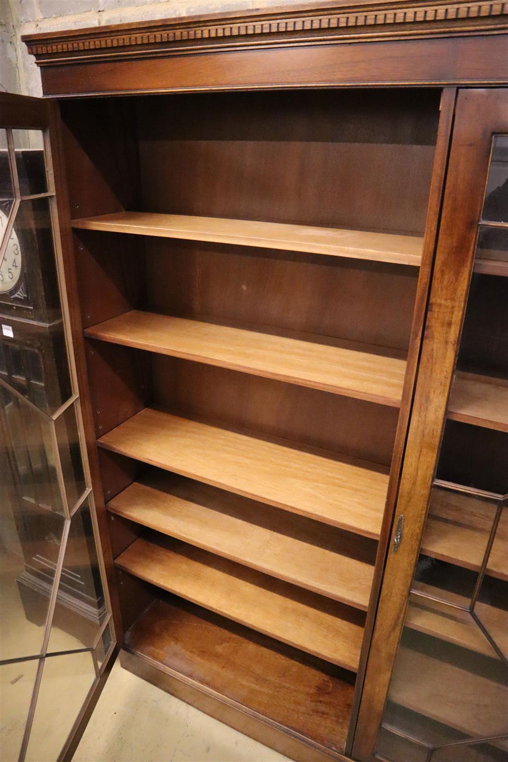 A Georgian style mahogany bookcase fitted a pair of astragal-glazed doors on plinth base, width 178cm, depth 32cm, height 196cm